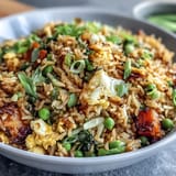 Vibrant veggie-packed fried rice with fresh spring peas and carrots, perfect for a healthy meal.  