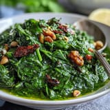 Vibrant dandelion pesto with garlic and pine nuts, spread on toasted baguette slices for a bright appetizer.