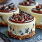 Mini cheesecake bites with Oreo crust, a decadent treat with creamy filling and chocolatey crunch.