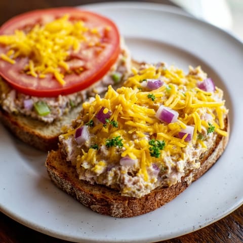 Open-faced Tuna Melt, a comfort food classic, with perfectly browned cheese and toasted bread.