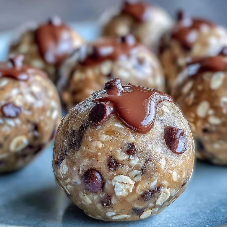 Wholesome peanut butter energy balls packed with oats, flaxseed, and dark chocolate chips for a nutritious treat.