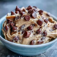 1. Edible protein cookie dough with chocolate chips, a healthy no-bake snack perfect for post-workout fuel.