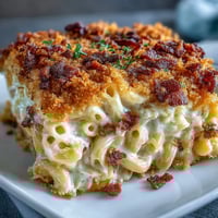 Comfort food mac and cheese bake with bacon crumbs, creamy and golden with a smoky, crispy topping.  