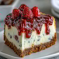 Festive no-bake cheesecake decorated with fresh blueberries and strawberries in an American flag pattern, perfect for Fourth of July celebrations.